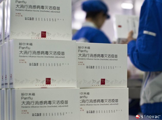 workers prepare to wrap the packages containing vials of H5N1 flu vaccine produced by Beijing-based drug maker Sinovac Biotech Ltd. in Beijing